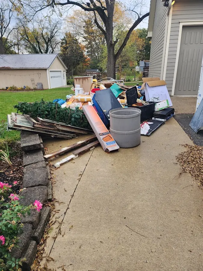 Dumpster being loaded with debris for 3 Yard Dumpster Rental in Newton